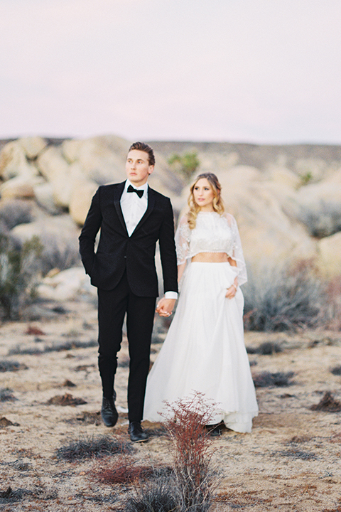 Joshua-tree-wedding-shoot-at-the-ruin-venue-bride-and-groom-walking-holding-hands