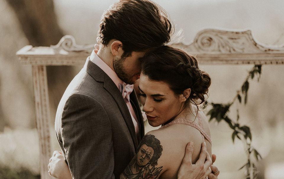 la-dolce-vita-shoot-bride-and-groom-bride-in-a-pink-colored-dress-with-lace-detailing-groom-in-grey-suit-pants-and-vest