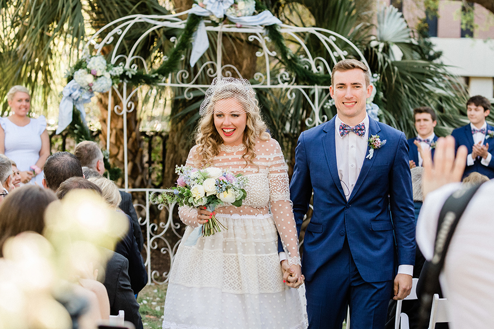 South-carolina-summer-outdoor-wedding-at-the-wickliffe-house-ceremony-bride-and-groom-holding-hands-walking