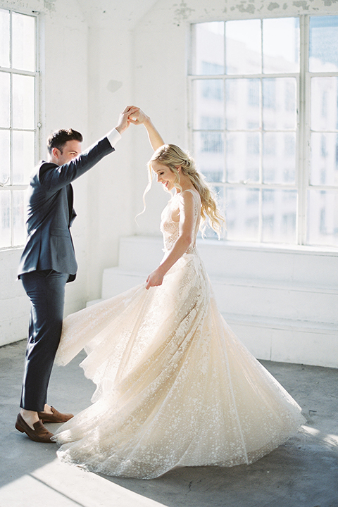 Los-angeles-modern-wedding-at-fd-photo-studio-bride-and-groom-holding-hands-dancing