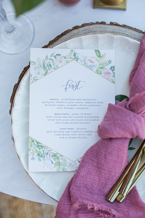 lot-8-close-up-on-plates-and-napkins-rose-colored-linnen-nakins-with-menu-card-in-white-with-floral-embellishments-and-pastel-calligraphy