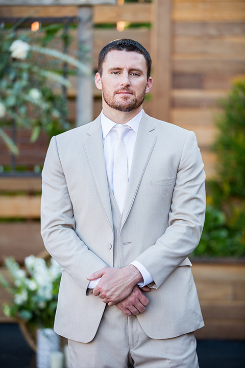 lot-8-groom-close-up-groom-in-fron-of-succulent-wall-with-hands-crossed-in-front-of-him