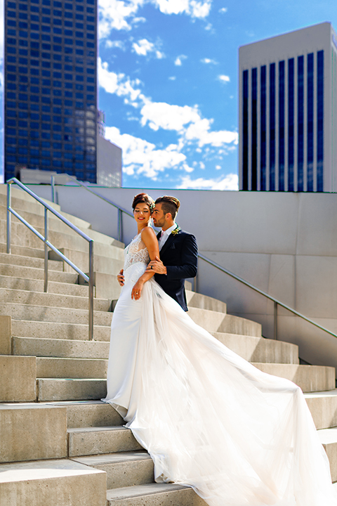 Downtown-los-angeles-wedding-shoot-at-oue-skyspace-bride-and-groom-hugging-on-stairs