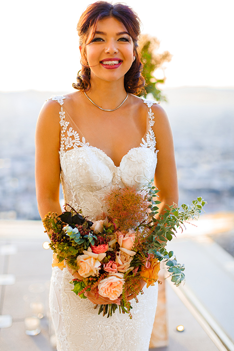 Downtown-los-angeles-wedding-shoot-at-oue-skyspace-bride-holding-bouquet-smiling