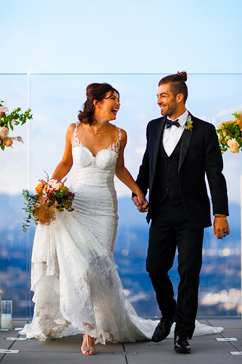 Downtown-los-angeles-wedding-shoot-at-oue-skyspace-ceremony-bride-and-groom-holding-hands