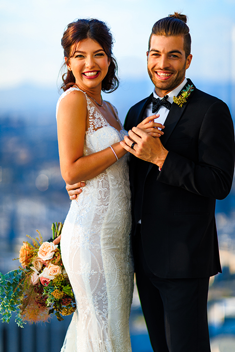 Downtown-los-angeles-wedding-shoot-at-oue-skyspace-ceremony-bride-and-groom-hugging-smiling