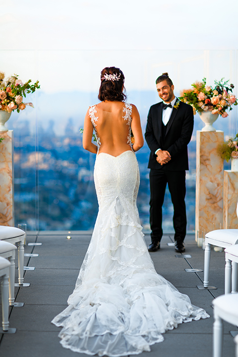 Downtown-los-angeles-wedding-shoot-at-oue-skyspace-ceremony-bride-and-groom-walking-down-the-aisle-smiling