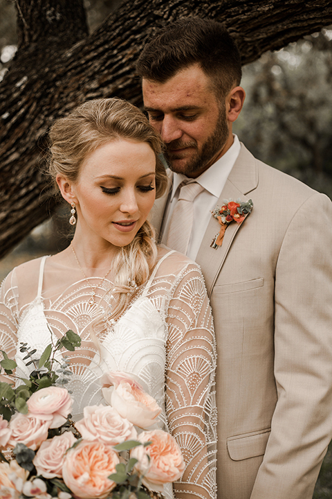 Texas-peaches-and-cream-wedding-shoot-at-carola-horse-ranch-bride-and-groom-hugging-close-up