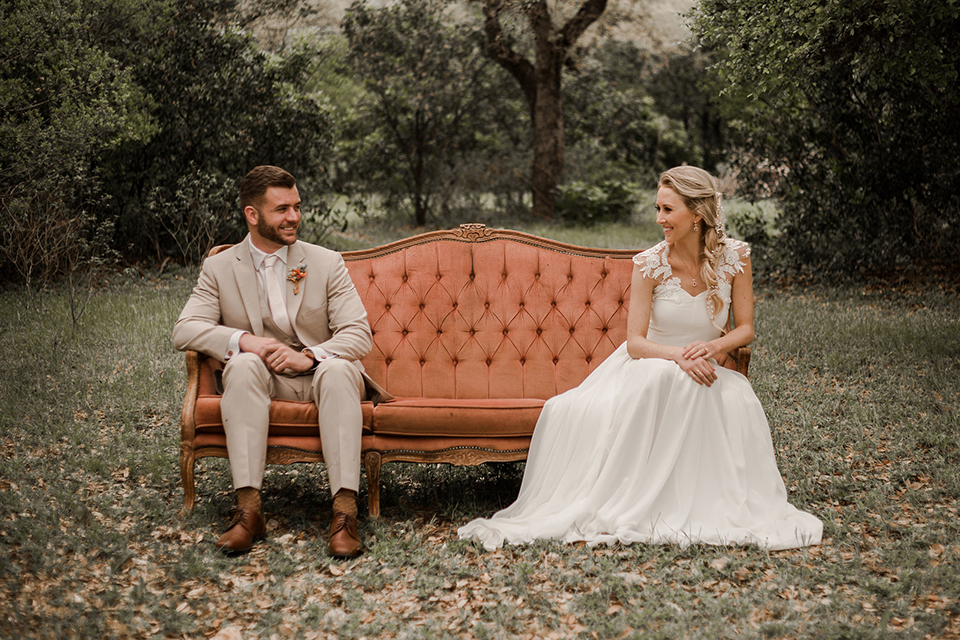 Texas-peaches-and-cream-wedding-shoot-at-carola-horse-ranch-bride-and-groom-sitting-on-couch