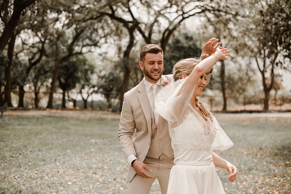 Texas-peaches-and-cream-wedding-shoot-at-carola-horse-ranch-bride-and-groom-standing-dancing