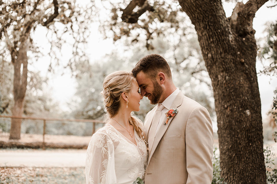 Texas-peaches-and-cream-wedding-shoot-at-carola-horse-ranch-bride-and-groom-standing-hugging