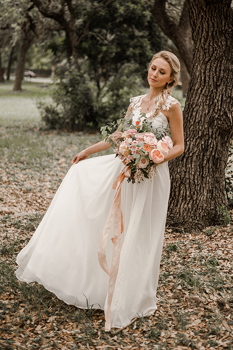 Texas-peaches-and-cream-wedding-shoot-at-carola-horse-ranch-bride-holding-bouquet