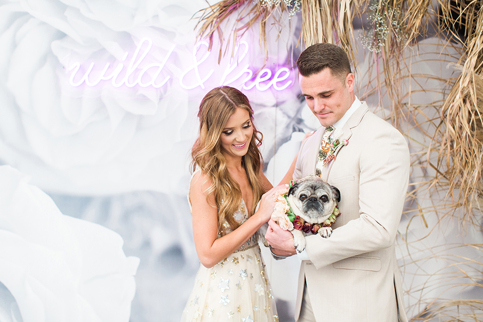 Los-angeles-garden-wedding-at-retreat-malibu-bride-and-groom-lounge-holding-dog