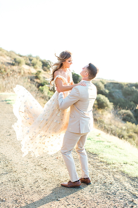 Los-angeles-garden-wedding-at-retreat-malibu-bride-and-groom-standing-holding-bride