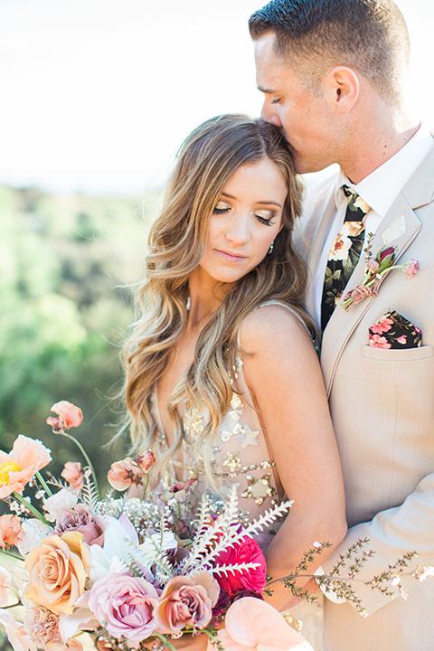 Los-angeles-garden-wedding-at-retreat-malibu-bride-and-groom-standing-hugging-and-kissing