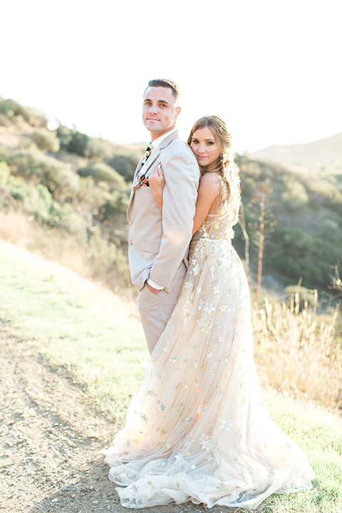 Los-angeles-garden-wedding-at-retreat-malibu-bride-and-groom-standing-hugging-and-smiling