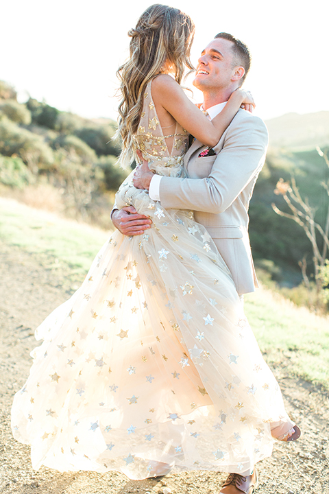 Los-angeles-garden-wedding-at-retreat-malibu-bride-and-groom-standing-hugging-bride