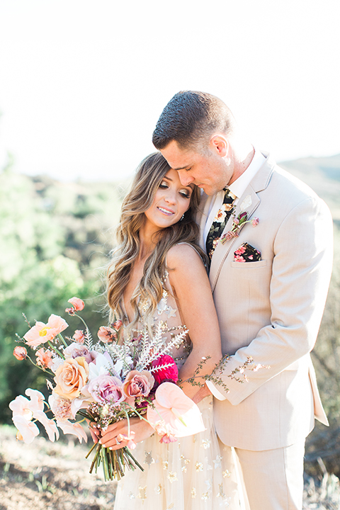 Los-angeles-garden-wedding-at-retreat-malibu-bride-and-groom-standing-hugging-close-up