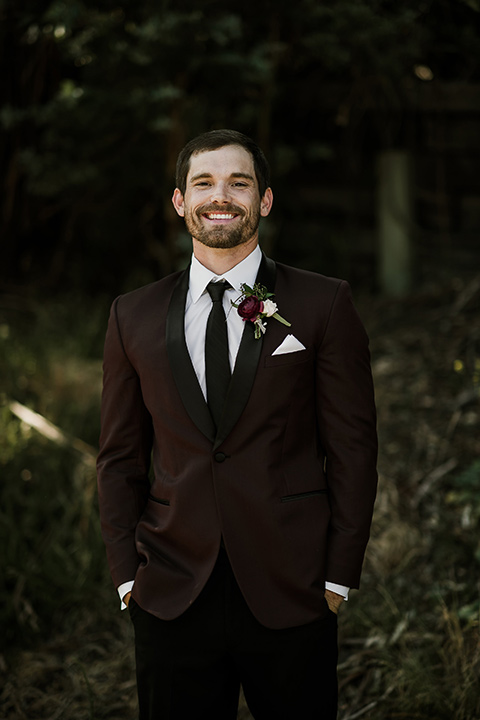 saddle-peak-groom-smiling-groom-in-a-burgundy-tuxedo-with-a-long-tie