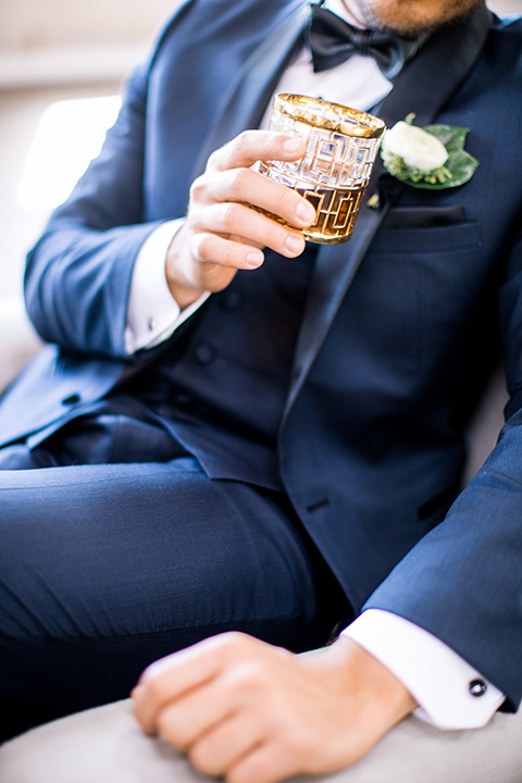 Same-sex-industrial-wedding-at-the-1912-groom-navy-tuxedo-close-up-holding-glass