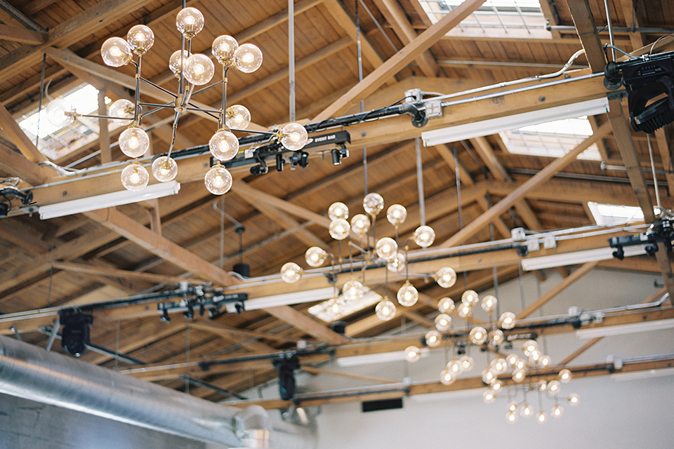 Same-sex-industrial-wedding-at-the-1912-table-set-up-with-hanging-lights