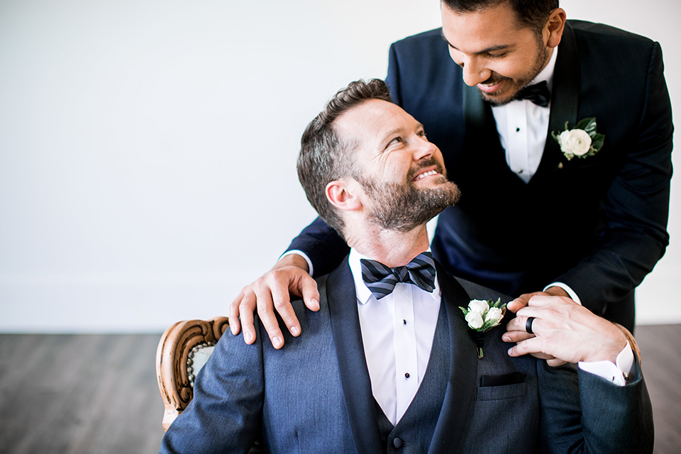 Same-sex-industrial-wedding-grooms-holding-hands-smiling