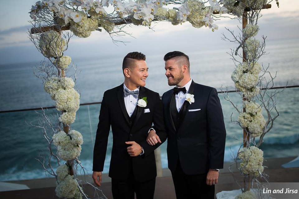 Laguna-beach-outdoor-wedding-same-sex-ceremony-grooms-holding-hands-walking