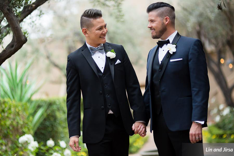 Laguna-beach-outdoor-wedding-same-sex-grooms-holding-hands-and-smiling