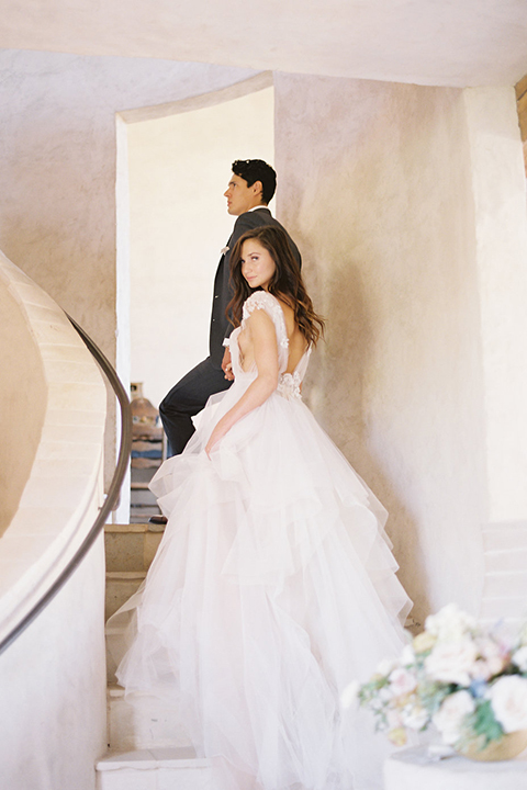 Santa-barbara-outdoor-wedding-at-sunstone-winery-bride-and-groom-holding-hands-on-stairs