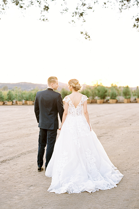 Southern-california-outdoor-wedding-at-the-orange-grove-bride-and-groom-standing-holding-hands