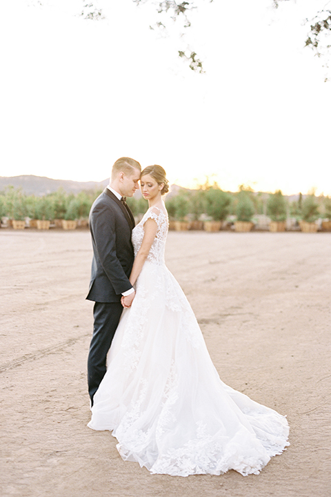 Southern-california-outdoor-wedding-at-the-orange-grove-bride-and-groom-standing-hugging-holding-hands