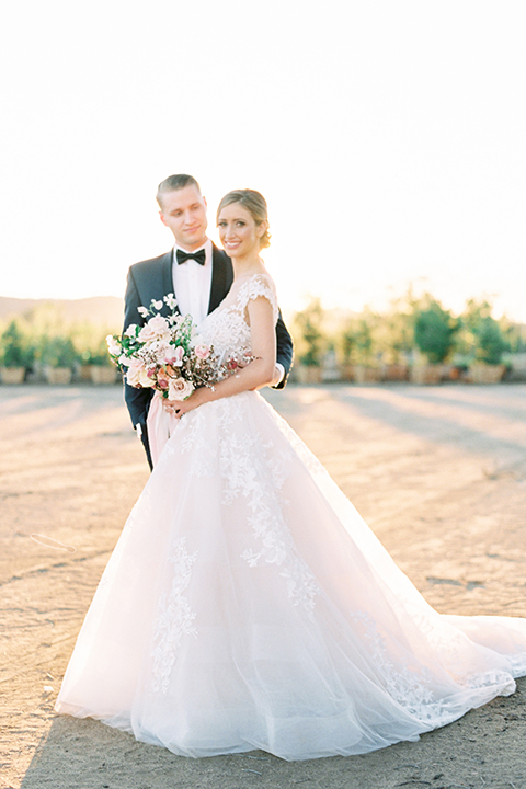 Southern-california-outdoor-wedding-at-the-orange-grove-bride-and-groom-standing-hugging