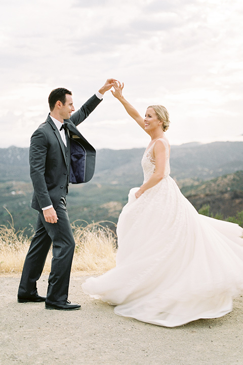 mountain-elopement-shoot-bride-and-groom-dancing-final¬-Bride-in-a-tulle-ball-gown-with-an-illusion-bodice-and-lace-detailing-groom-at-sweetheart-table-groom-in-a-grey-tuxedo-with-a-black-bowtie