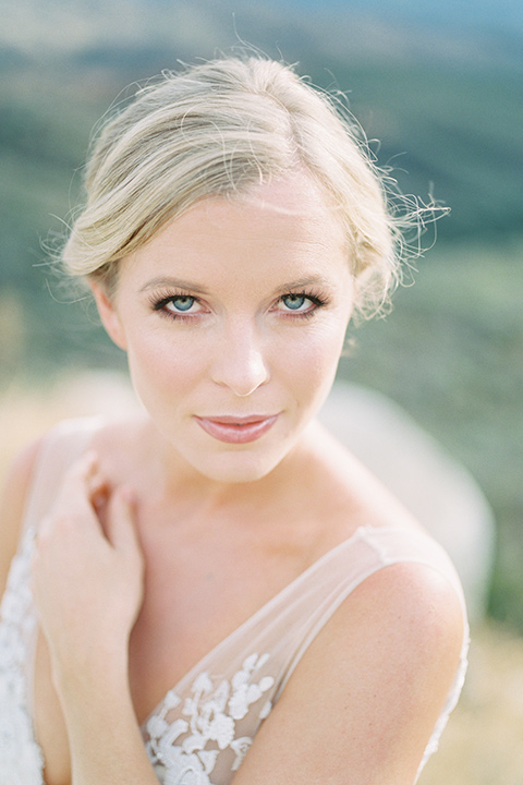 mountain-elopement-shoot-bride-at-camera-Bride-in-a-tulle-ball-gown-with-an-illusion-bodice-and-lace-detailing-groom