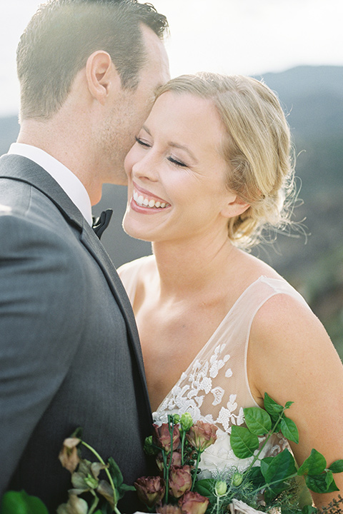 mountain-elopement-shoot-close-up-on-couple-bride-walking-bride-at-camera-Bride-in-a-tulle-ball-gown-with-an-illusion-bodice-and-lace-detailing-groom-at-sweetheart-table-groom-in-a-grey-tuxedo-with-a-black-bowtie