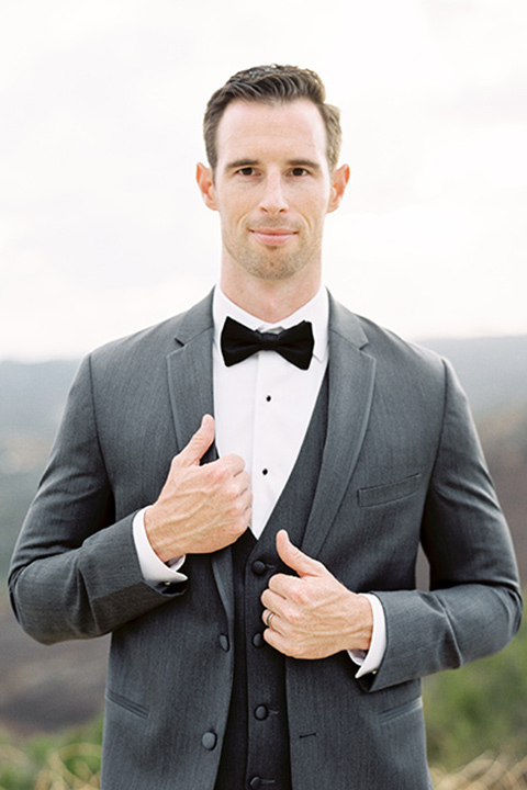 mountain-elopement-shoot-groom-looking-at-camera-groom-in-a-grey-tuxedo-with-a-black-bowtie