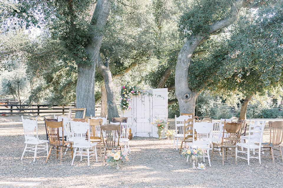 alice-in-wonderland-shoot-ceremony-set-up-with-different-style-of-chairs-in-white-and-natural-wood