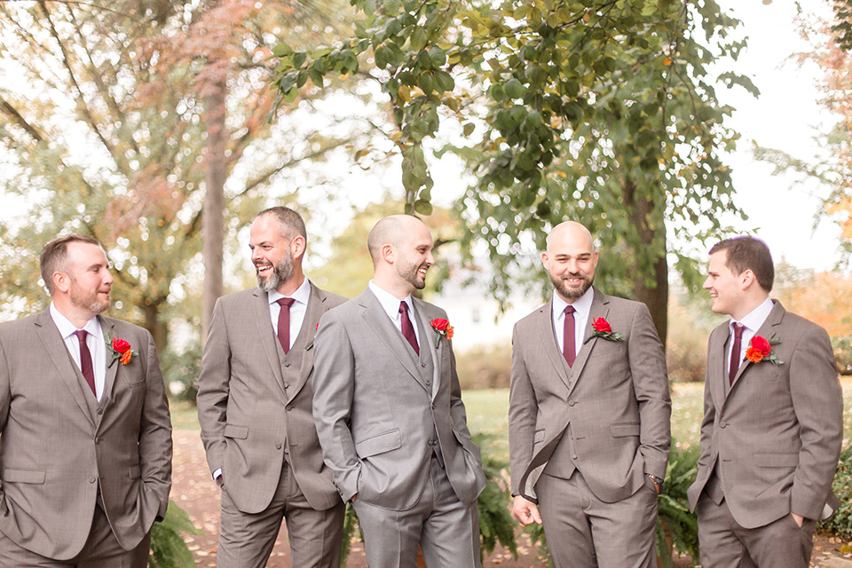 groom and groomsmen in brown suits with red ties and brown shoes