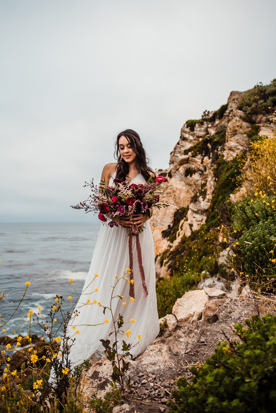 avila-beach-elopement-shoot-bride-in-a-soft-flowing-gown-with-a-strapless-neckline-and-a-big-bouquet-of-flowers