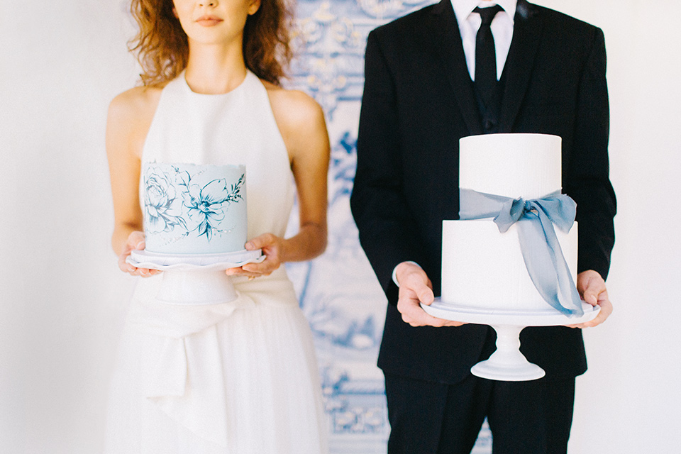 Rancho-las-lomas-blue-shoot-bride-and-groom-holing-cake-the-bride-wore-a-white-flowing-gown-with-a-halter-neckline-and-simple-mamkeup-the-groom-wore-a-simple-black-suit-with-a-black-long-tie