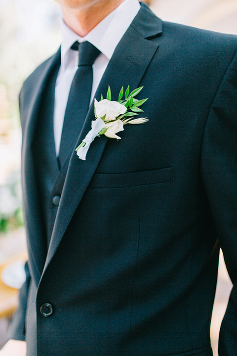 Rancho-las-lomas-blue-shoot-groom-attire-close-up-in-a-black-suit-with-a-black-long-tie