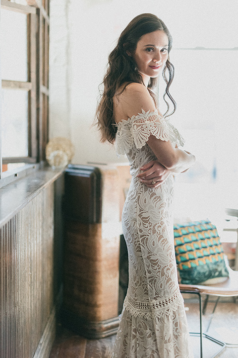 Brooklyn-Shoot-bride-looking-at-camera-in-a-lace-boho-gown-with-an-off-the-shoulder-detail