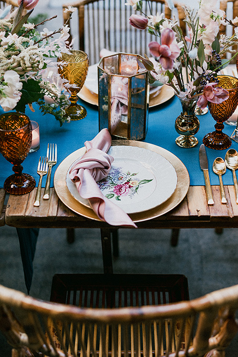 Brooklyn-Shoot-table-décor-with-a-teal-linen-and-wooden-tables-with-gold-flatware