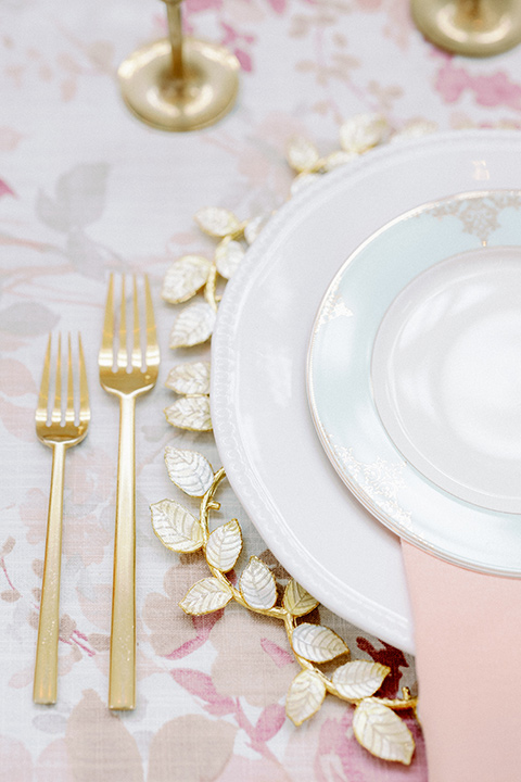  pink floral table linen with gold charger plates and flatware