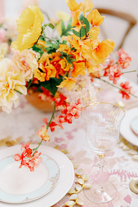 pink and white floral linen with gold and white flatware and decor