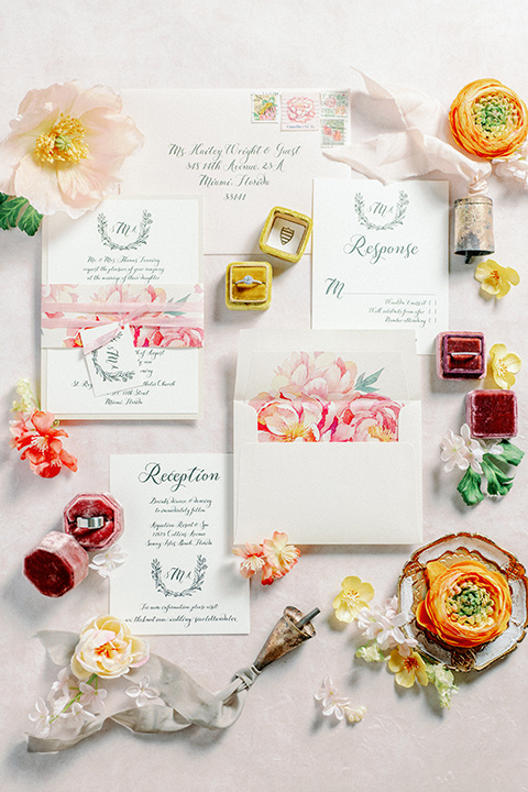 white invitations with a pink watercolor design