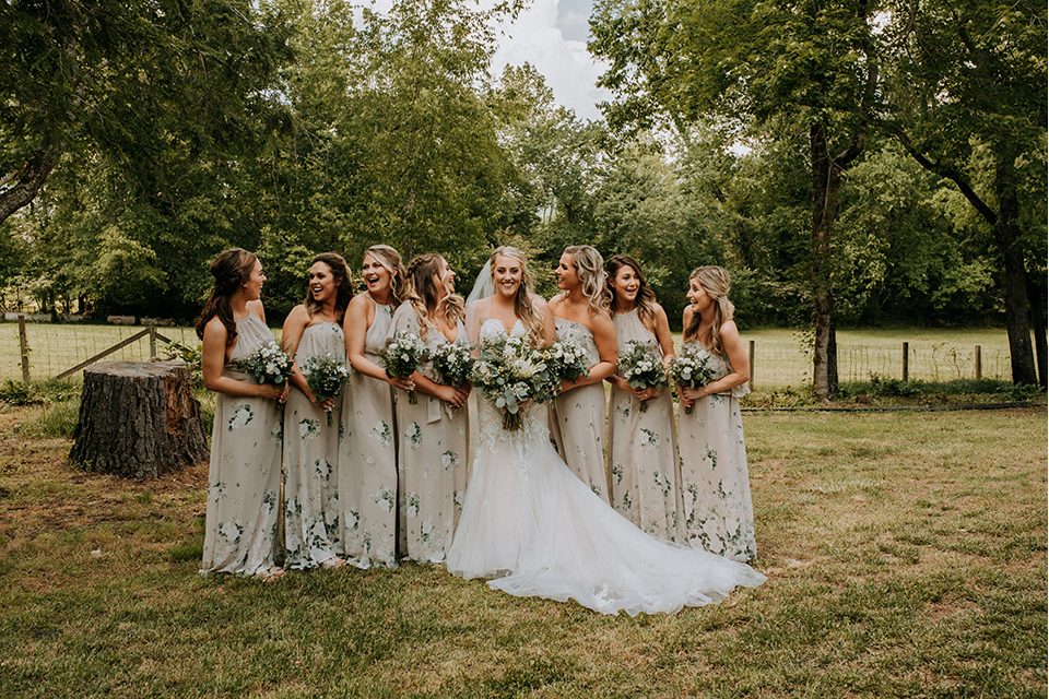 Horse-Range-Vista-bridesmaids-in-sage-dresses-with-green-and-white-flowers-on-it-bride-in-a-lace-mermaid-gown-with-a-long-veil