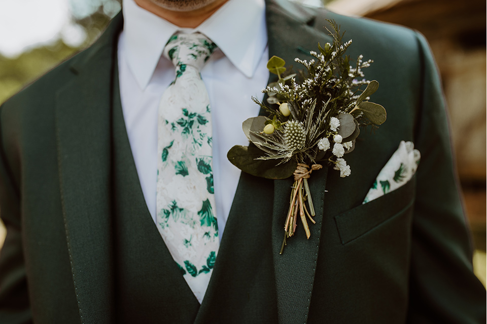 Horse-Range-Vista-close-up-on-groom-in-a-green-suit-with-a-floral-tie