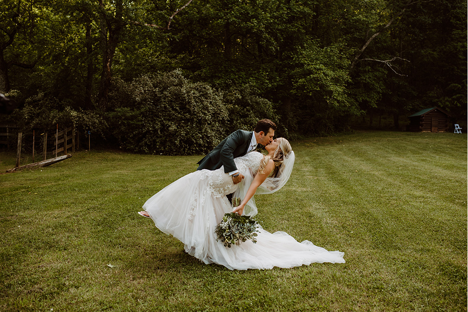 Horse-Range-Vista-groom-dipping-bride-bride-in-a-lace-mermaid-gown-with-a-long-veil-groom-in-a-green-suit-with-a-floral-tie