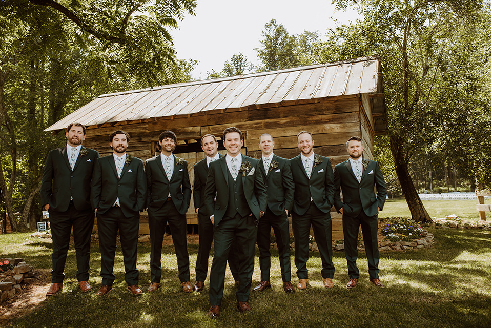 Horse-Range-Vista-groomsmen-and-groom-in-a-green-suits-with-a-floral-ties